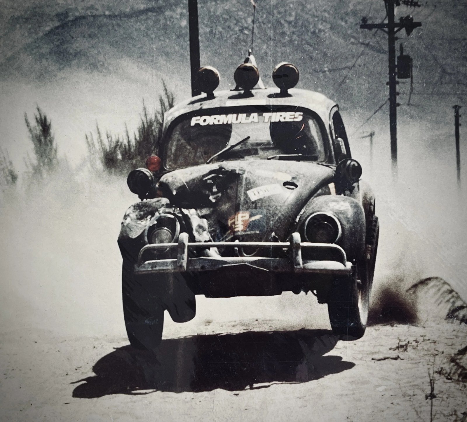 A Class 11 VW Bug racing on a Baja dirt road